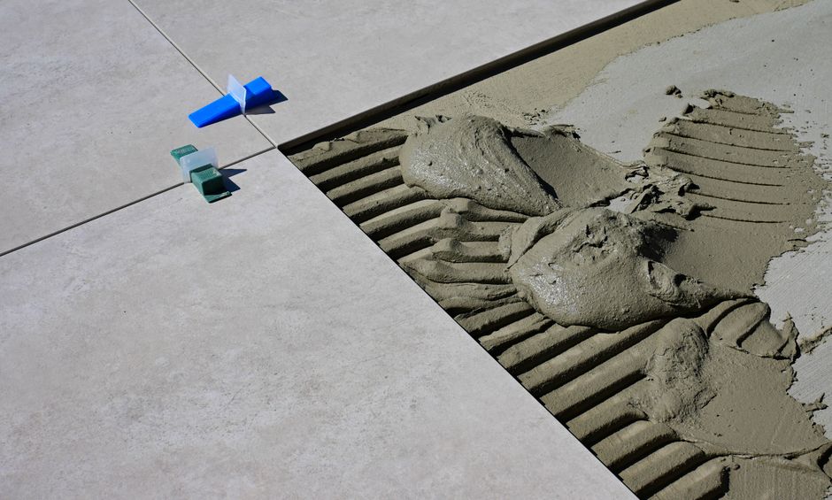 Close-up of tile grout lines during floor installation, highlighting the importance of proper grout sealing.