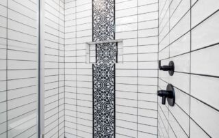 Close-up of tiled shower wall with grout lines between ceramic tiles