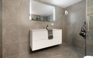 Close-up of sealed tile grout lines on a clean bathroom floor