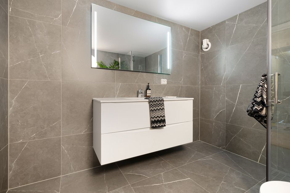Close-up of sealed tile grout lines on a clean bathroom floor